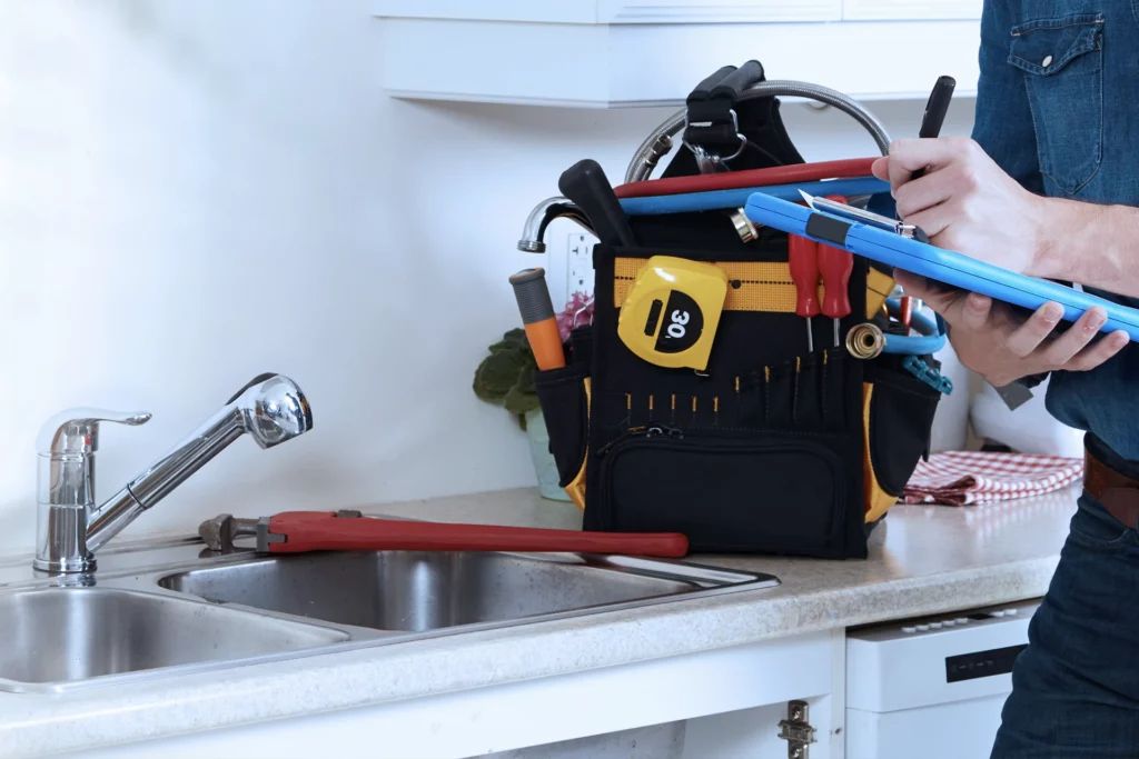 Leaking tap repair Sligo – plumber’s tools at a kitchen sink